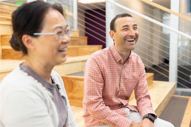 BioMarin employee Javier Femenia sits with a coworker